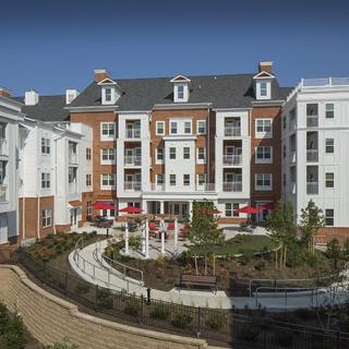 A modern residential apartment building with landscaped gardens.