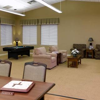 A cozy living room with comfortable seating and a pool table.