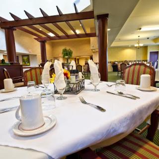 A neatly set dining table in a restaurant interior.