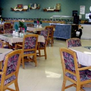 An empty restaurant dining area with tables and chairs.
