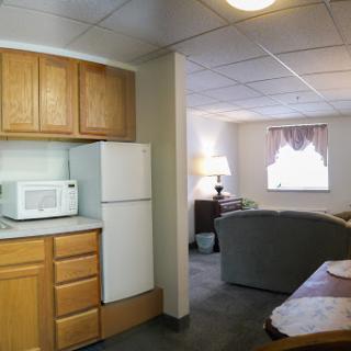 A cozy apartment featuring a small kitchen and a living area.