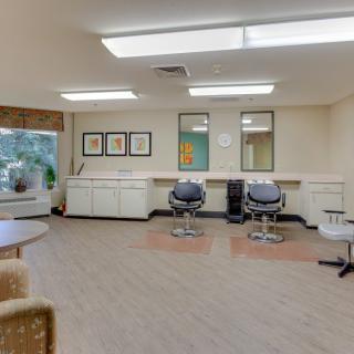 A modern hair salon with styling chairs and mirrors.