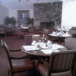 An elegant indoor dining area with set tables and comfortable seating.