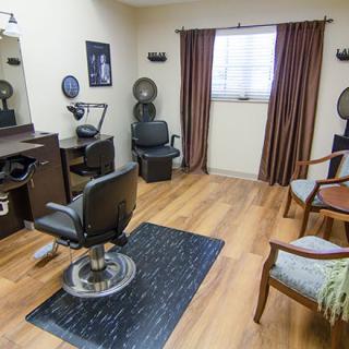 A cozy hair salon with multiple styling stations and comfortable seating.