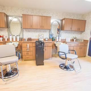 A well-organized hair salon featuring modern barber chairs and ample storage.