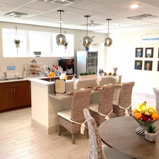 A modern kitchen and dining area with pendant lighting and cozy seating.