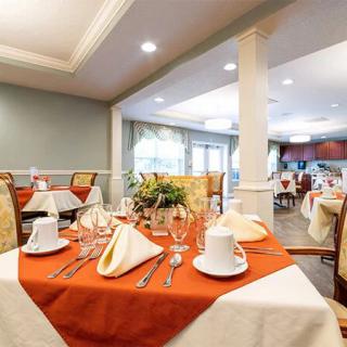 An elegantly set dining area with neatly arranged tables and stylish dcor.