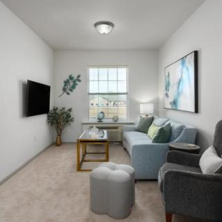 A cozy, modern living room with a sofa, television, and decorative accents.