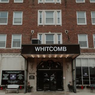 The entrance of the Whitcomb hotel with a prominent awning.