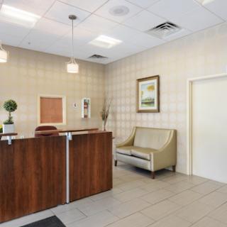 A well-designed reception area featuring a stylish desk, comfortable seating, and decorative elements.