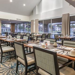 A modern restaurant dining area with neatly arranged tables and chairs.