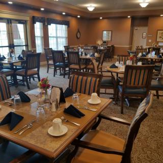 An elegant dining room with neatly arranged tables and chairs, ready for guests.