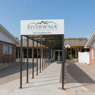 Entrance of the Riverwalk building with a signage display.