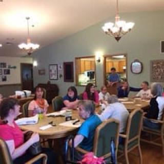 A group of people gathered indoors for a community meeting.