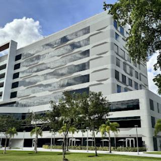 A modern architectural building surrounded by greenery.
