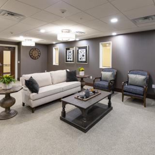 A stylish living room with a sofa, chairs, coffee table, and elegant decor.