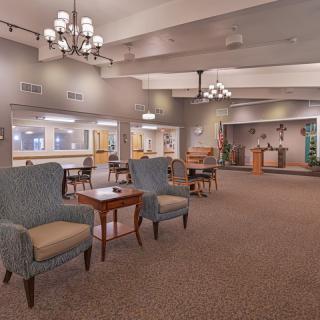 Spacious lobby with comfortable seating and elegant chandeliers.