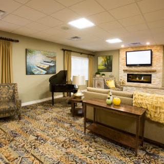 A cozy living room featuring a piano, comfortable seating, and stylish decor.