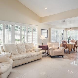 A bright, modern living room with comfortable seating and a dining area.