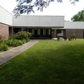 A modern house with a spacious lawn and garden.