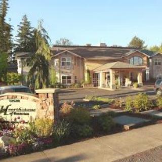 A well-maintained building with a landscaped garden at its entrance.