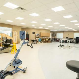 A spacious and well-equipped physical therapy and rehabilitation center featuring various exercise machines.