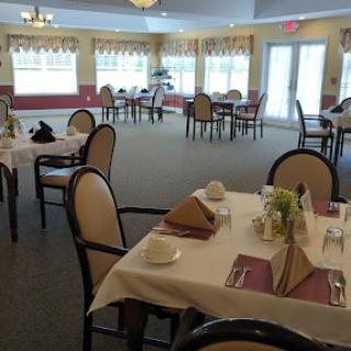 A spacious and elegantly arranged dining area with neatly set tables, ready for guests.