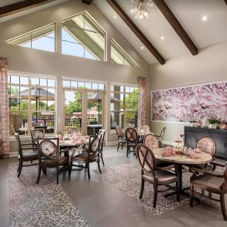A beautifully designed dining area with large windows, wooden beams, and a cherry blossom mural.
