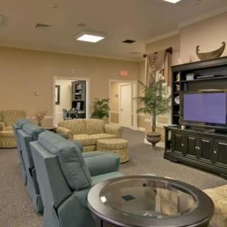 A spacious living room with comfortable seating and a large TV.
