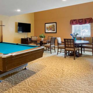 A cozy game room featuring a pool table, television, and seating area.