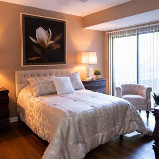 A cozy bedroom with a comfortable bed, elegant decor, and warm lighting.