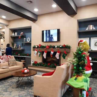 A beautifully decorated living room ready for the holiday season, featuring a cozy seating area and festive Christmas decor.