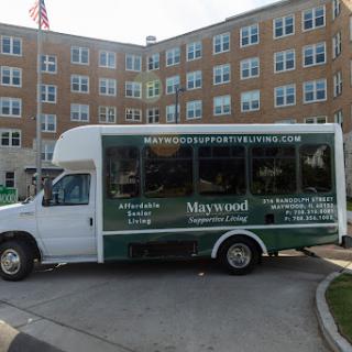 A shuttle bus parked near a residential building, showcasing its service offerings.