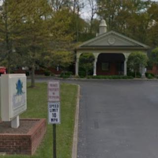 Entrance to a facility with a welcoming gazebo and landscaped surroundings.