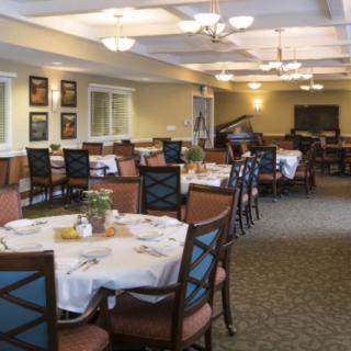 A spacious dining area with neatly arranged tables and chairs, ready for guests.