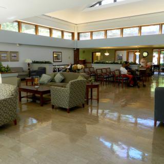 A spacious and modern lobby area with comfortable seating and large windows.