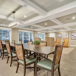 A spacious dining room with elegant furnishings and ample natural light.