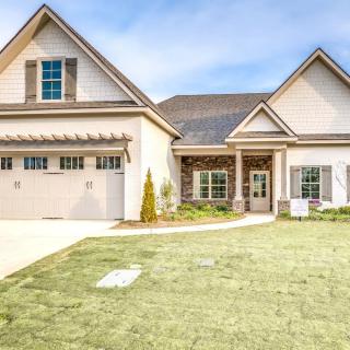 A modern suburban house with a well-maintained lawn and driveway.