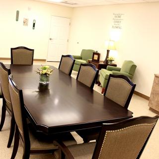 A neatly arranged conference room with a large table and chairs.