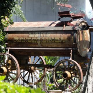 A rustic antique wagon displayed outdoors.