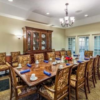 Elegant dining room with a large table and ornate chairs.