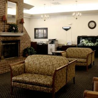 A cozy lobby with sofas and a fireplace, providing a comfortable waiting area.