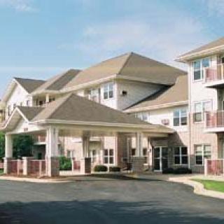 A multi-story apartment complex with a covered entrance.