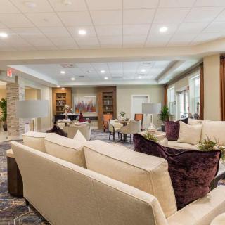 A modern and comfortable lounge area with sofas and accent lighting.