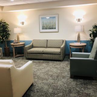 A cozy lounge area featuring comfortable seating and soft lighting.