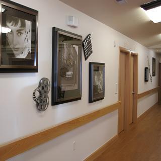A hallway adorned with framed photographs and artwork.