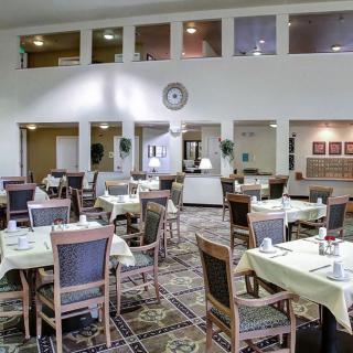 A cozy dining area with neatly arranged tables and chairs, ready for guests.