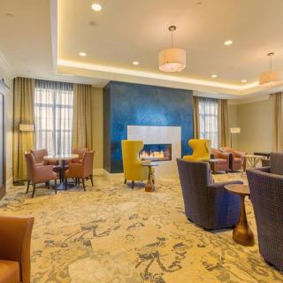 A modern lobby with a cozy seating area and fireplace.