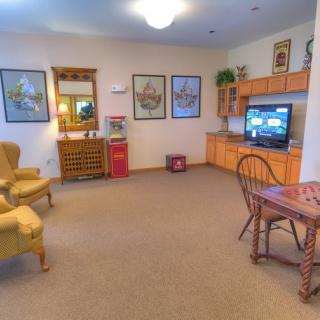 A cozy living room with comfortable seating, a small TV, and decorative elements.