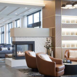 A modern lobby with a cozy seating area and fireplace.